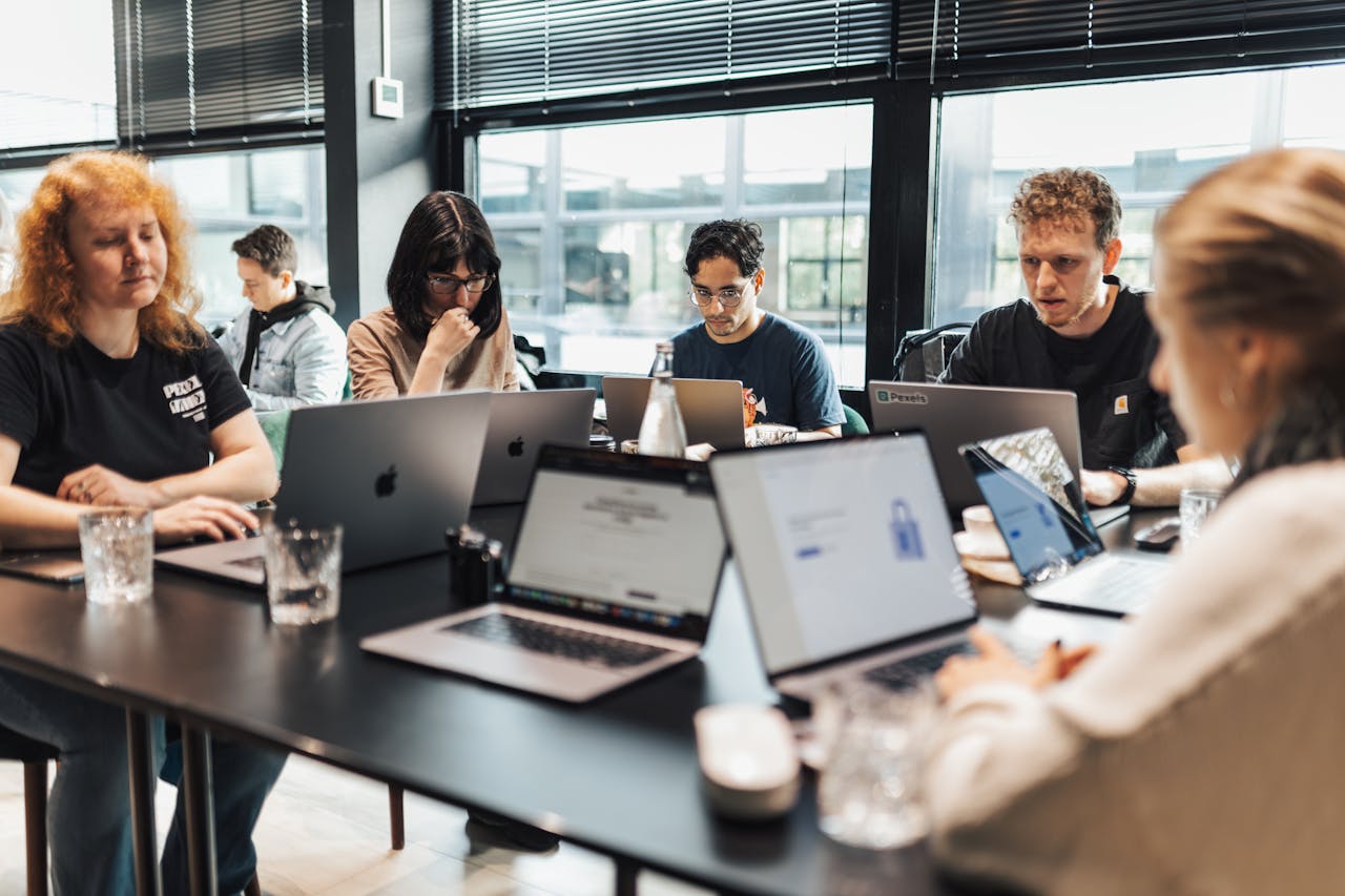 Focused team engaged in discussion and planning at a modern office setting.